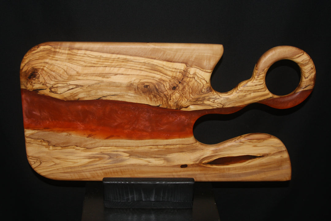 Ancient olivewood with a soft red epoxy resin charcuterie board