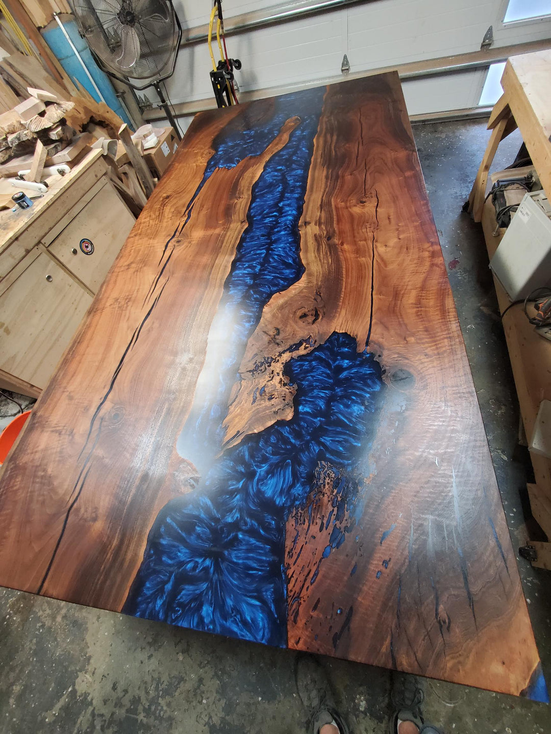Highly figured large claro walnut with blue blood epoxy resin conference table